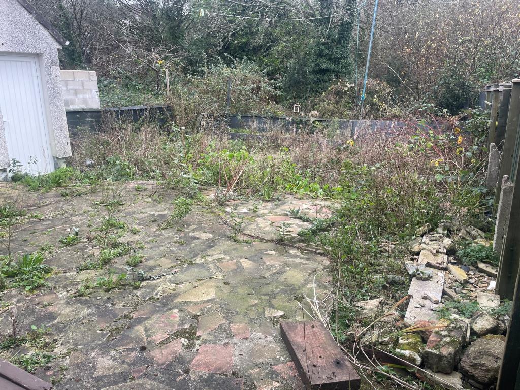 Lot: 48 - PROPERTY FOR IMPROVEMENT WITH OFF-ROAD PARKING - Rear overgrown garden with outside W.C.